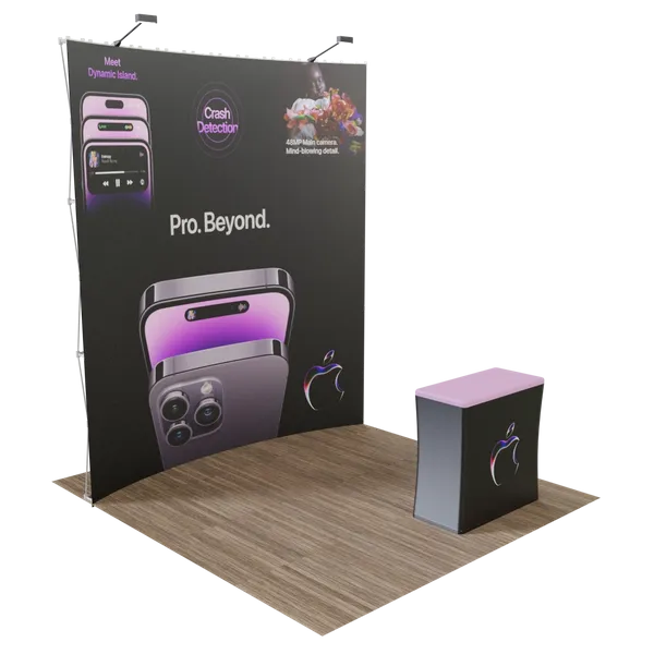 A promotional booth with vivid graphics of a smartphone highlights features like 'Meet Dynamic Island,' 'Crash Detection,' and text stating 'Pro. Beyond.' Wooden flooring suggests an indoor setting.